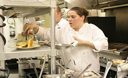 Stella plating up and working hard in the busy kitchen